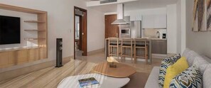A modern living room with a flat-screen TV, a coffee table, and a sofa with patterned cushions. - Crown Penthouse - Luxury & Views   All inclusive (Puerto Plata)