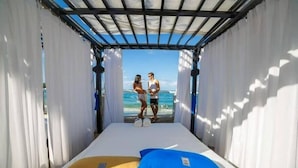 A room with a bed, two pillows, and a view of the ocean. - Crown Penthouse - Luxury & Views   All inclusive (Puerto Plata)