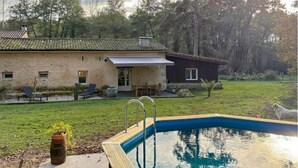 A house with a swimming pool, a patio with outdoor furniture, and a dog nearby. - Nice home in Noaillan (Noaillan)
