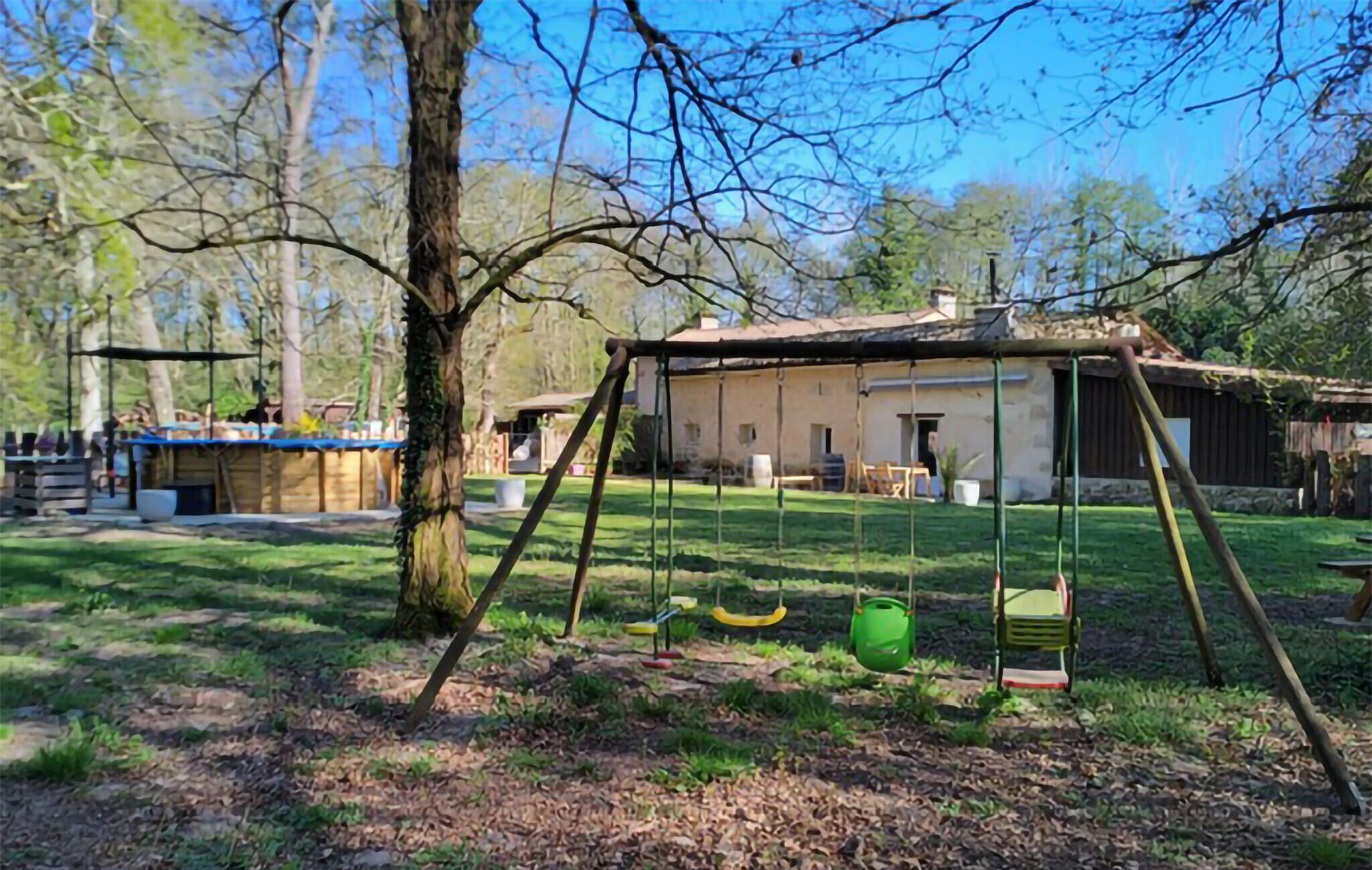 A rustic wooden swing set in a backyard with a house in the background.