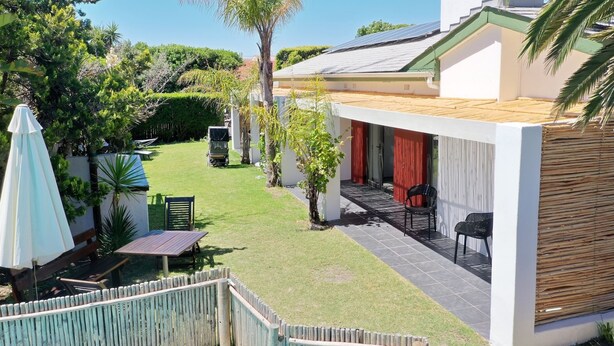 A modern house with a patio, a covered outdoor seating area, and a solar panel on the roof. - 2stay apartment Calla Bloubergstrand  (Cape Town)