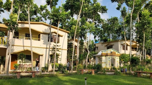A residential area with multiple buildings, a grassy lawn, and trees.