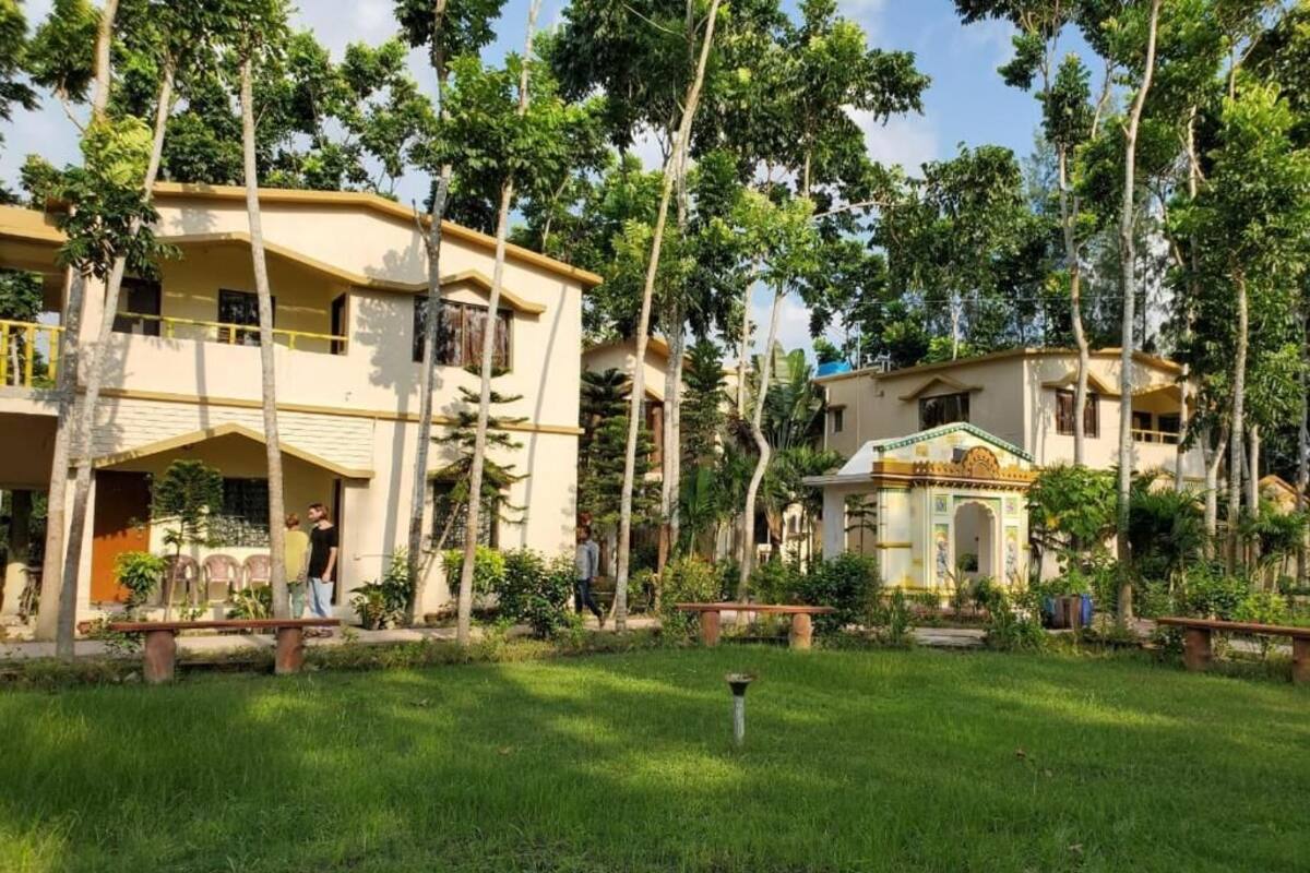 A residential area with multiple buildings, a grassy lawn, and trees.