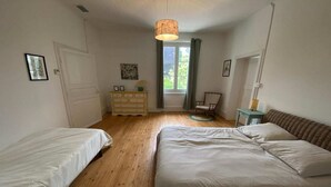 A bedroom with two single beds, a dresser, a chair, and a window with curtains. - Charming French Countryside Escape with Pool (Barry d'Islemade)