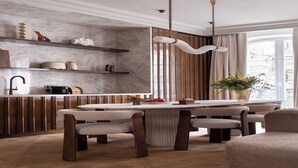 A modern kitchen with marble countertops, wooden cabinets, and a central island with seating. - Luxury A/C Apt - 10P/4BDR - Arc de Triomphe (Paris)