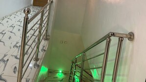 A staircase with marble tiles and metal railings, leading to a room with a wooden door. - Make Yourself at Home with Luxury Living and Unmatched Comfort (Osogbo)
