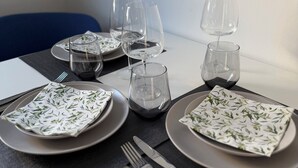 A neatly set dining table with plates, cutlery, and glasses, ready for a meal. - Luxury apartment - Charming 2 room apartment (Augsburg)