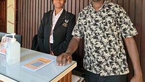 A reception desk with a sign reading "Presidential Villas" and a date stamp of 02/10/2026. - Precious villas hotel  (Kampala)