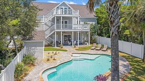 A two-story house with a covered patio and a swimming pool. - Rolling Retreat 77–Gulfview Escape–Sleeps 16 (Santa Rosa Beach)