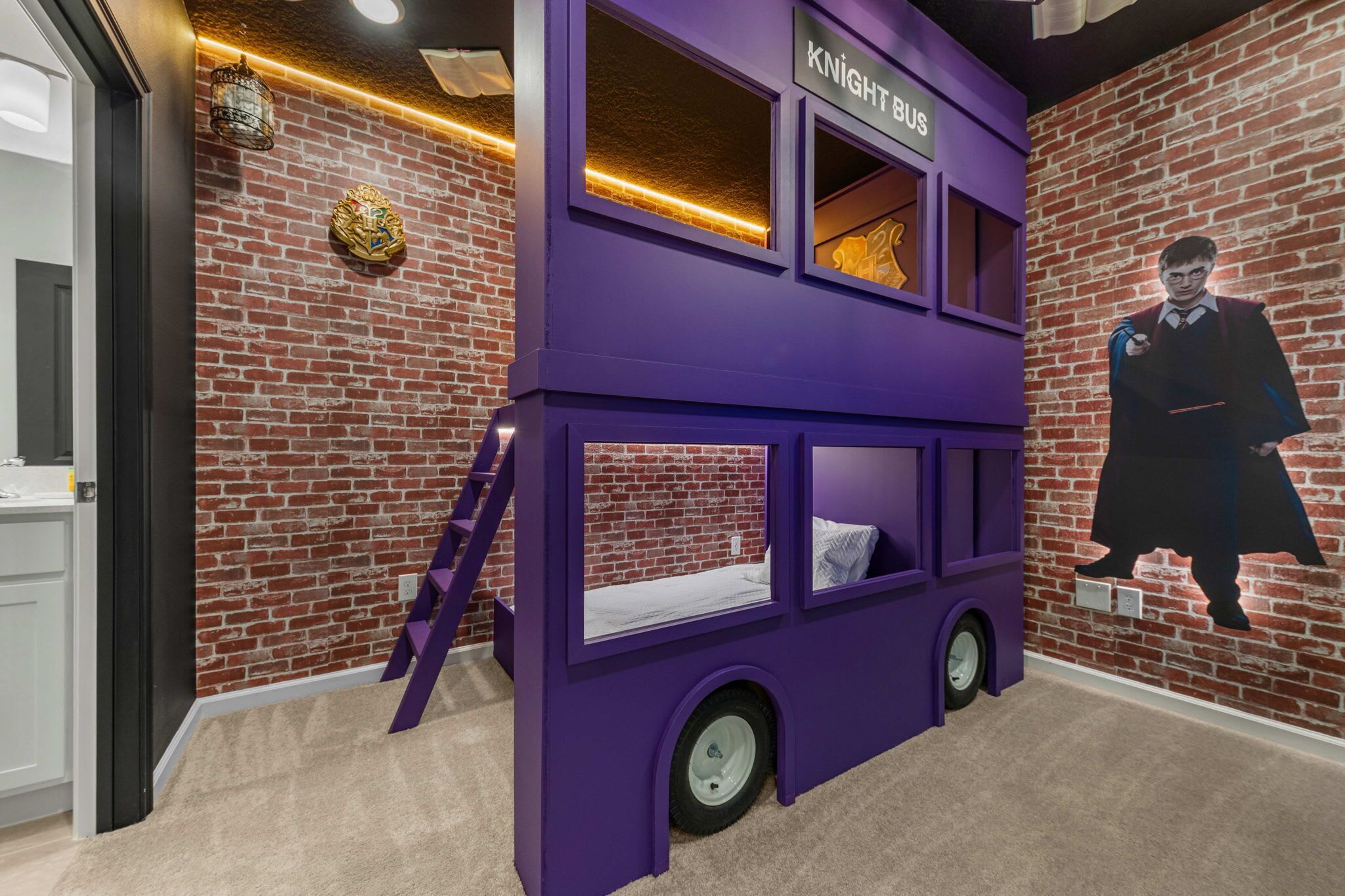A purple double-decker bus-shaped room with a brick wall and a Knight Bus sign.