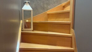 A wooden staircase with a lantern on the first step. - Le Petit Cosy - King Size Bed, Quiet & Parking (Vaucelles)