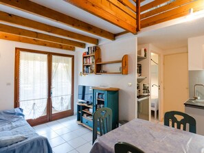 A cozy room with a bed, a desk, a chair, and a bookshelf. - Cozy T2 Mezzanine near Lagoon with A/C, Pool, WiFi, Parking - Sleeps 4 (Gruissan)