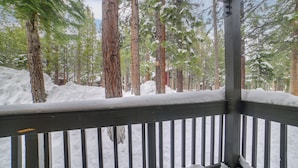 A snow-covered deck with a railing, surrounded by tall evergreen trees. - 1 Mi to Village & Eagle Lodge! Extended Stay Unit (Mammoth Lakes)