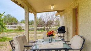 An outdoor patio with a table set for dining, a grill, and a covered area with a door. - Yard, Patio & Grill! Florence Home Near Monastery (Florence)