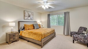A bedroom with a bed, nightstands, a chair, a ceiling fan, and a window with curtains. - Yard, Patio & Grill! Florence Home Near Monastery (Florence)
