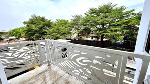A balcony with a patterned railing, a tiled floor, and trees in the background. - La Villa Resort And Hotel  (Awka)