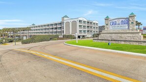 A multi-story hotel with a sign reading "Casa del Mar Suites and Rentals." - Casa Del Mar 309 1 Bedroom Condo (Galveston)
