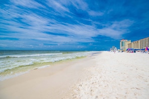 A beach with a hotel in the background. - Phoenix V 115 2 Bedroom Condo (Orange Beach)