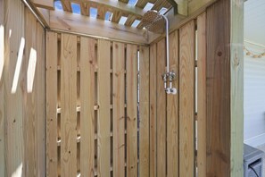 A wooden shower enclosure with a skylight and a showerhead. - Bayview Anchor-Pet Friendly Home with Dock (Atlantic Beach)