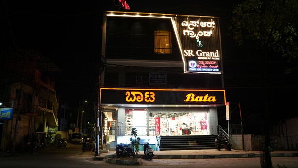 A building with a sign for 'Bata' and 'SR Grand' indicating a commercial space for rent.