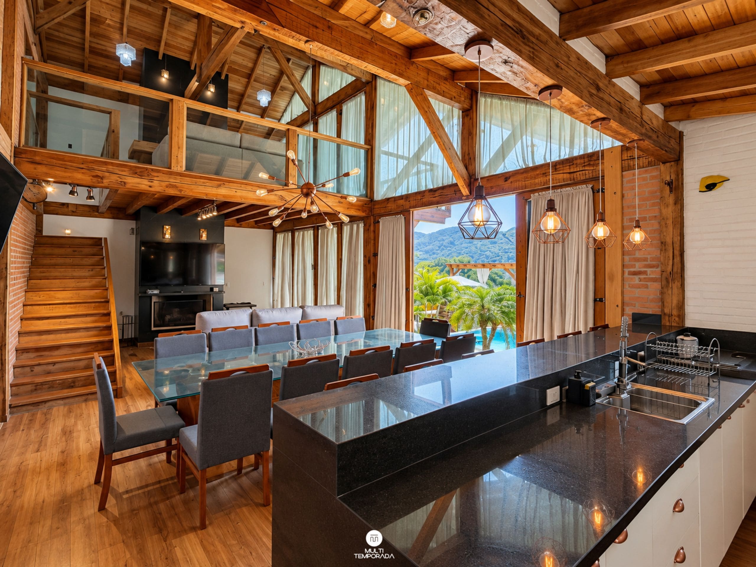 Una cocina espaciosa con una isla grande, vigas de madera y vistas al exterior.