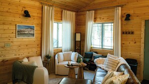A cozy cabin interior with wooden walls, a sofa, a loveseat, and a coffee table. - Private Sauna I 1.7 mi to Lutsen Mountain I Ski I Bike I Hike (Lutsen)