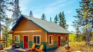 A small cabin with a pitched roof, a front porch with two Adirondack chairs, and a red door. - Private Sauna I 1.7 mi to Lutsen Mountain I Ski I Bike I Hike (Lutsen)