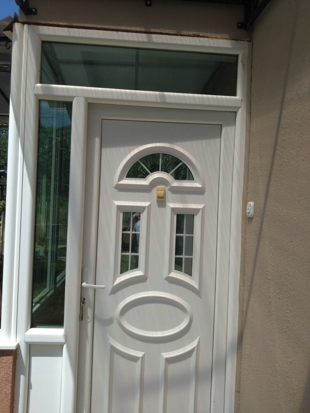 A white door with a glass panel and a small window above it.