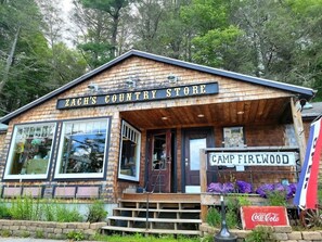A rustic wooden building labeled "Zach's Country Store" with large windows and a Coca-Cola sign. - Heron's Perch Beautiful Pondside Home with Screened Porch (Brunswick)