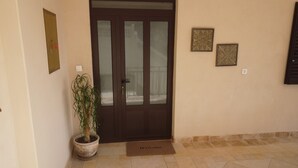 A door with frosted glass panels, a potted plant, and two decorative wall pieces. - Lady M in Rabac - Istrien / Lady M in Rabac - Appartement für 4 Personen AP1 (Rabac)