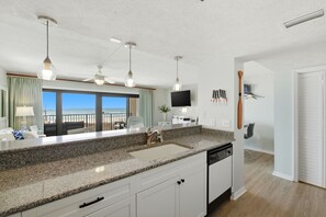 A modern kitchen with granite countertops, a built-in dishwasher, and pendant lighting. - Ocean Breesze West 201 - New Listing!! Spacious Gulf Front Property! (Perdido Key)