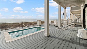 A wooden deck with a pool, lounge chairs, and a view of the ocean. - NEW Rental!!! Viviana 1~Beach Lovin - Private Pool Beach Front Home (Perdido Key)
