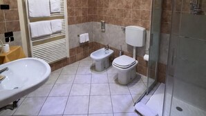 A modern bathroom with a large sink, bidet, toilet, and glass shower stall. - The Dome - Panoramic Rooms (Ferrara)