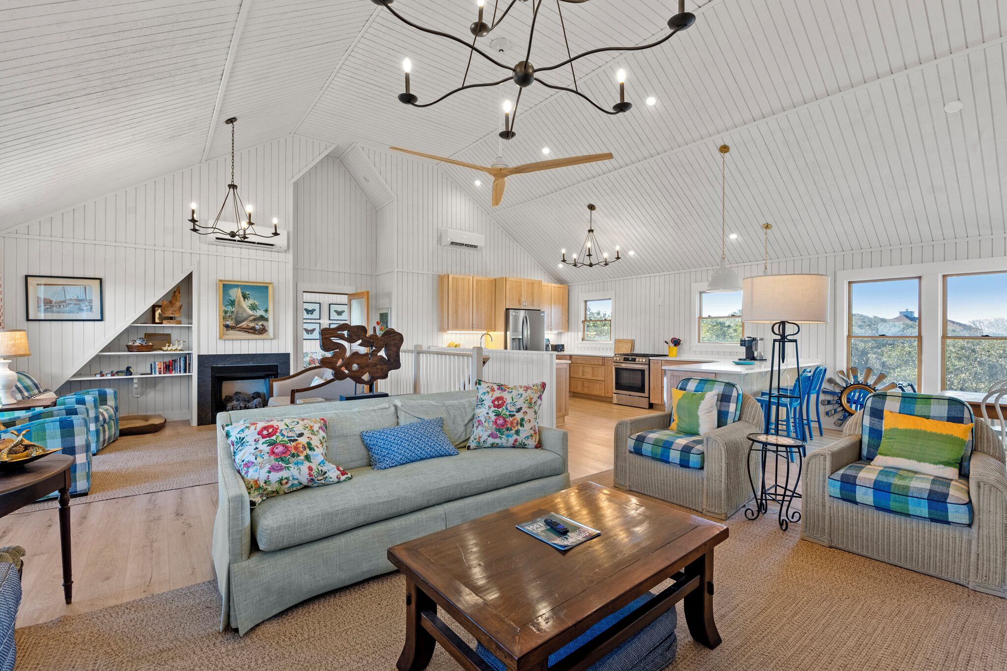 A spacious living area with a fireplace, a dining area, and a kitchen.