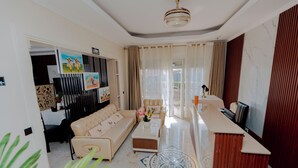 A modern living room with a sofa, coffee table, and a decorative rug.