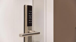 A modern door with a numeric keypad lock.