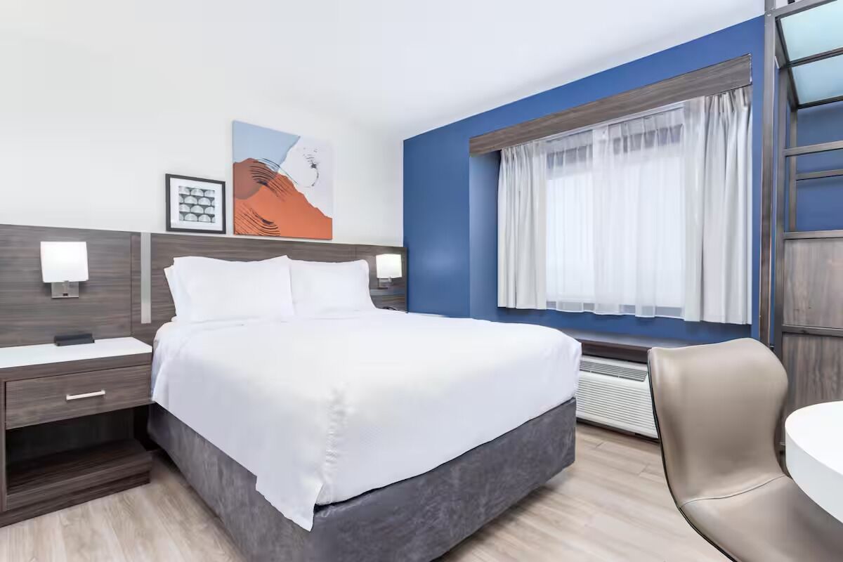 Sink into a cozy king bed beside soft lighting.