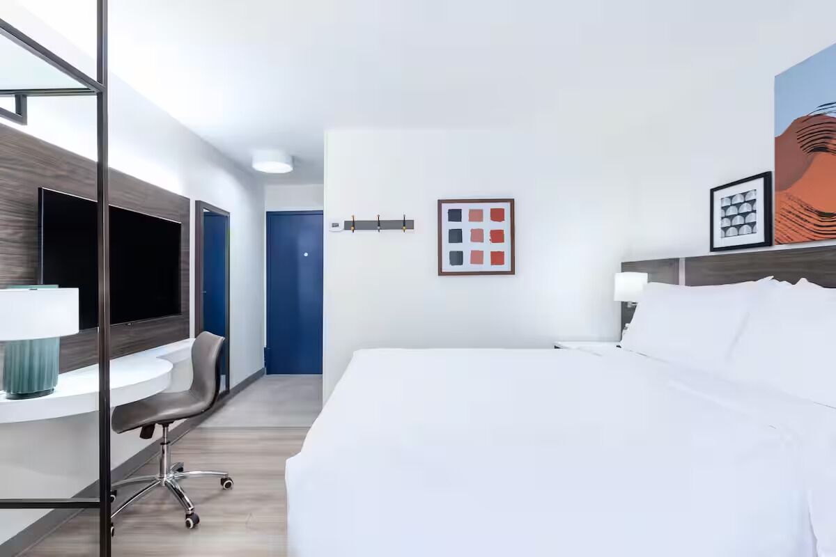 Recharge in a serene king bed after a full day.
