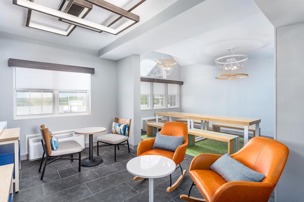 Unwind with coffee in this bright, modern communal lounge.