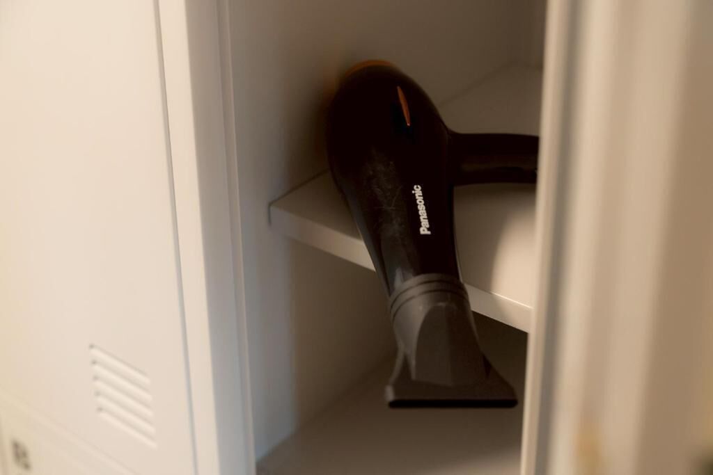 A Panasonic hair dryer on a white shelf.