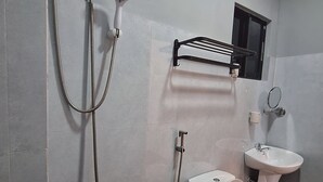 A bathroom with a toilet, sink, and shower. - Basilia Guest House - 1 BDR with bathroom (Santa Fe)