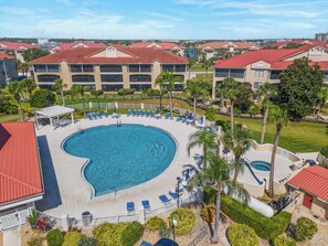 A resort with a large circular pool surrounded by lounge chairs and palm trees. - 🌴Waterfront Resort | 🐾Pet Friendly | Screened Balcony | Bouchelle Island 203 (New Smyrna Beach)