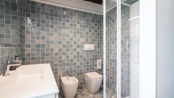 Eenpersoonskamer, uitzicht op tuin | Badkamer | Een douche, gratis toiletartikelen, een haardroger, badjassen