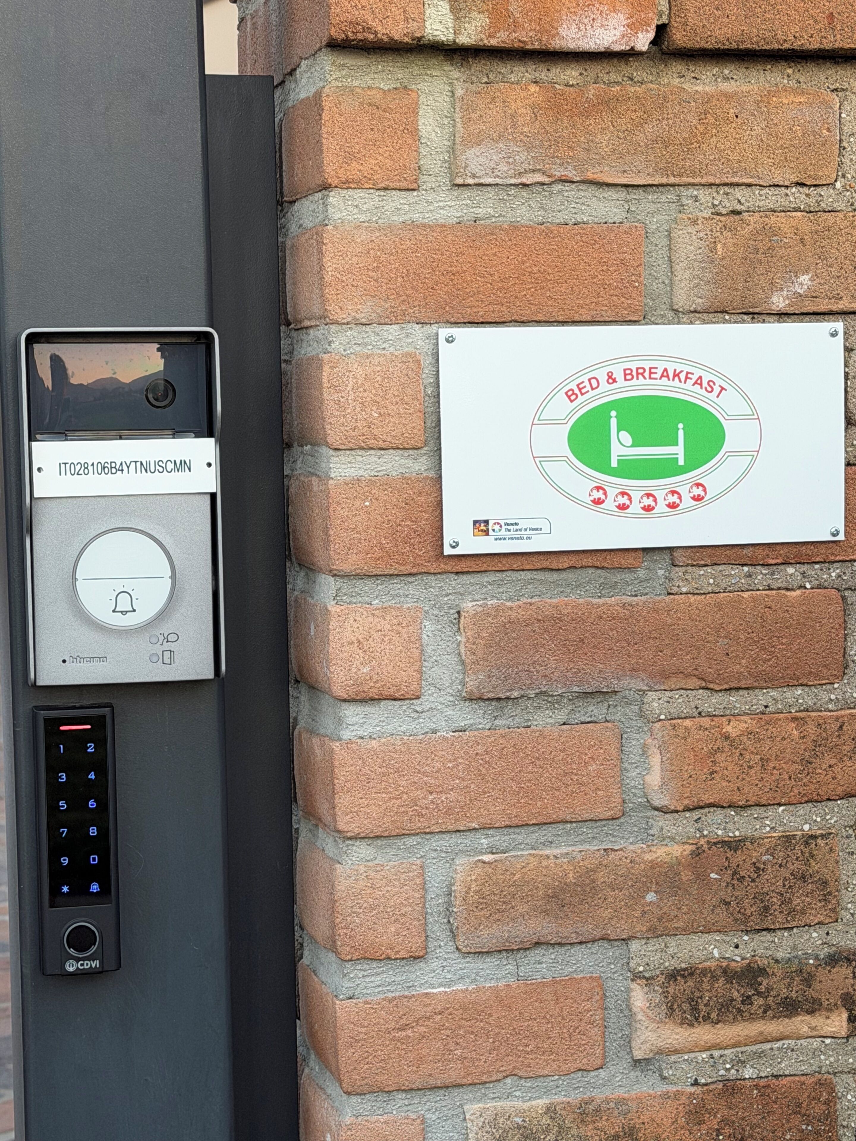 A wall-mounted intercom and a sign indicating a bed and breakfast.