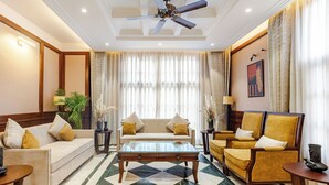 A spacious living room with a checkered floor, a sofa, armchairs, and a coffee table. - The Himalayan Residency (Rampur)