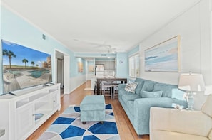 A spacious living room with a view of a pool, a dining area, and a kitchen. - PELICANS WATCH 322 - Short Walk to Beach (Myrtle Beach)