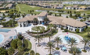 An aerial view of a resort with a central courtyard, multiple pools, and a golf course in the background. - Last Minute Disney Getaway! Townhouse with Private Pool. Book Now! #15072 (Orlando)