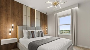 Un dormitorio moderno con una cama grande, una pared de acento de madera, una mesita de noche integrada y un ventanal con vistas.