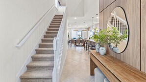 A staircase leading to a dining area with a wooden bench and potted plants. - Last Minute Disney! Private Pool, Hot Tub, Game Room & Themed Bedrooms. Book Now! #150825 (Orlando)