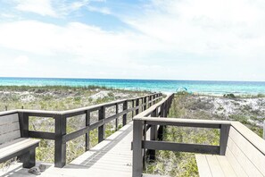 A wooden boardwalk leading to a beach with clear blue water. - 3BR Emerald Escape /Steps from Beach (Panama City Beach)